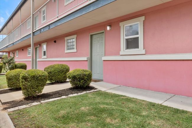 Entrance to property featuring stucco siding and a lawn | Image 20