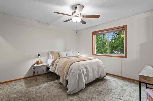 The primary bedroom is spacious with soft carpet to give it a cozy feeling. | Image 11