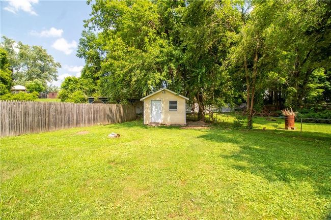 View of yard featuring a storage unit | Image 17
