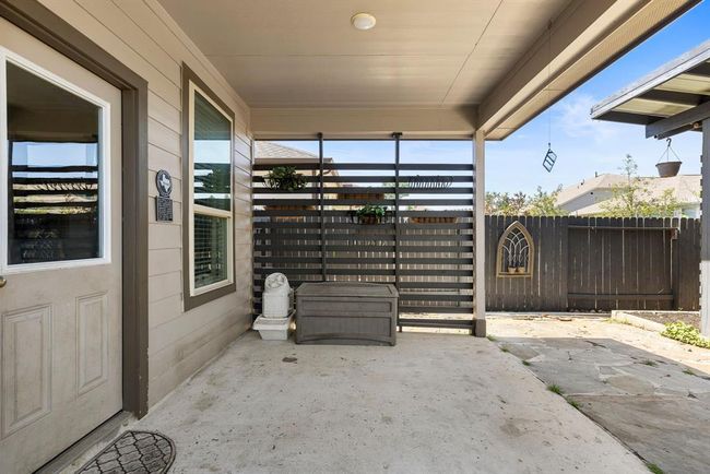 The outdoor area is perfect for relaxing. Notice the modern slate privacy wall with planters which add a coziness to the space. | Image 38