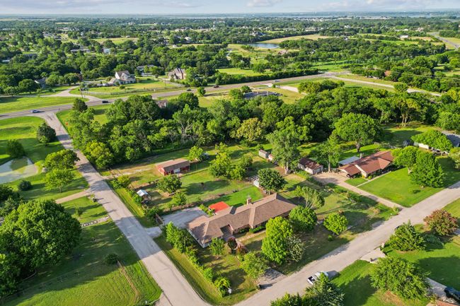 Aerial overview of property's location featuring a nearby body of water and a tree filled landscape | Image 17