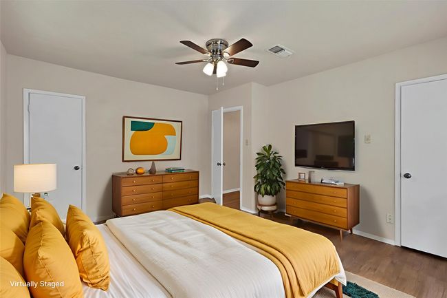 Bedroom featuring wood finished floors and ceiling fan | Image 6