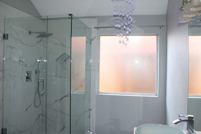 Full bathroom featuring toilet and a marble finish shower | Image 23