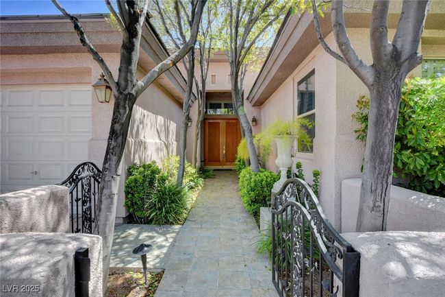 Entrance to property with a garage and stucco siding | Image 4