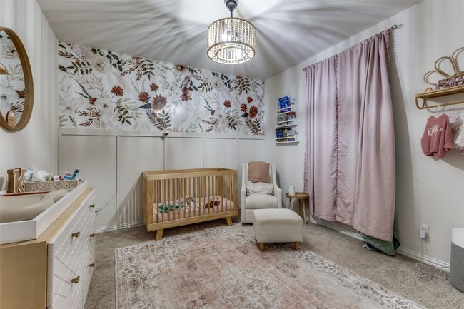 Bedroom featuring a chandelier, a crib, carpet, and a wainscoted wall | Image 14