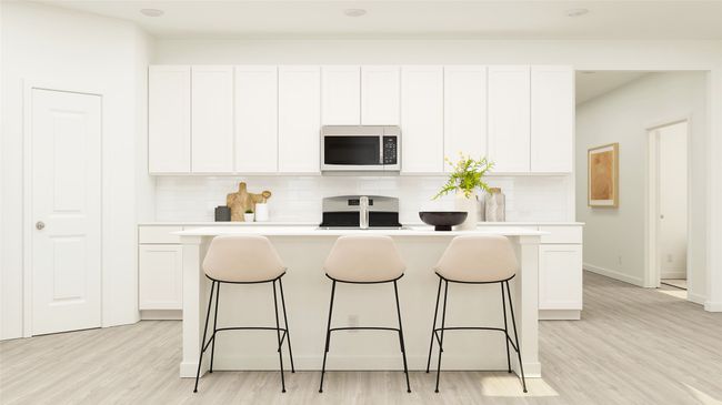 Kitchen with a breakfast bar, a kitchen island, decorative backsplash, and white cabinetry | Image 11