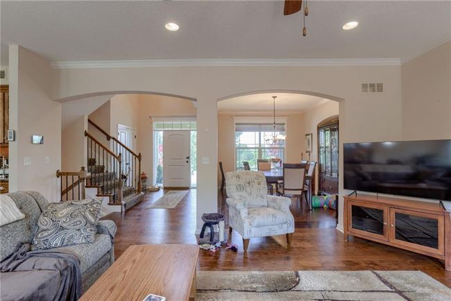 Handsome Family Room with Fireplace Open to the Kitchen with a Wall of Windows | Image 5