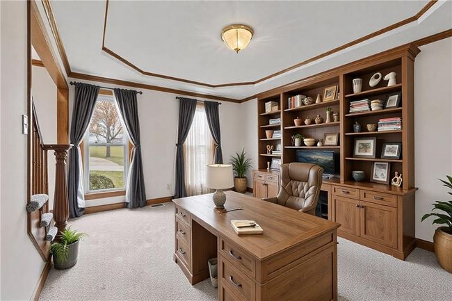 Office area featuring a healthy amount of sunlight, light colored carpet, crown molding, and baseboards | Image 6