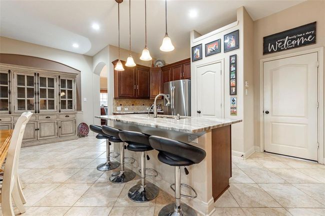 Another view of the beautiful island kitchen with undermount lighting. | Image 24