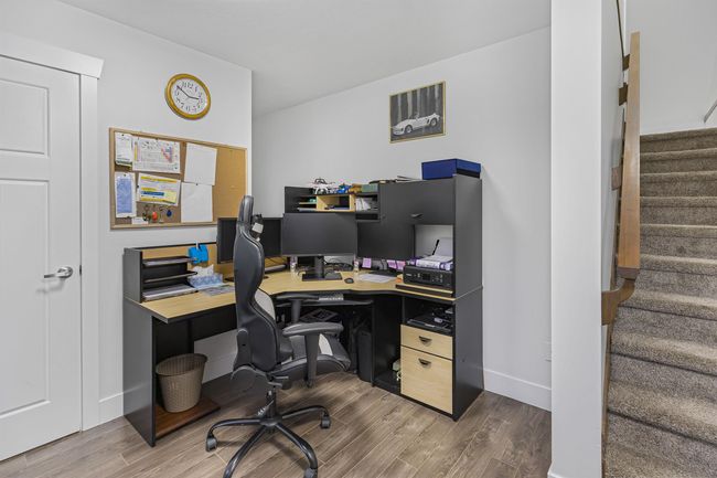 Bedroom is used as an office space, located below Main with wood finished floors | Image 18