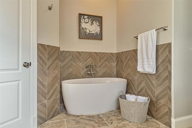Luxurious bathroom featuring a sleek freestanding tub. | Image 16
