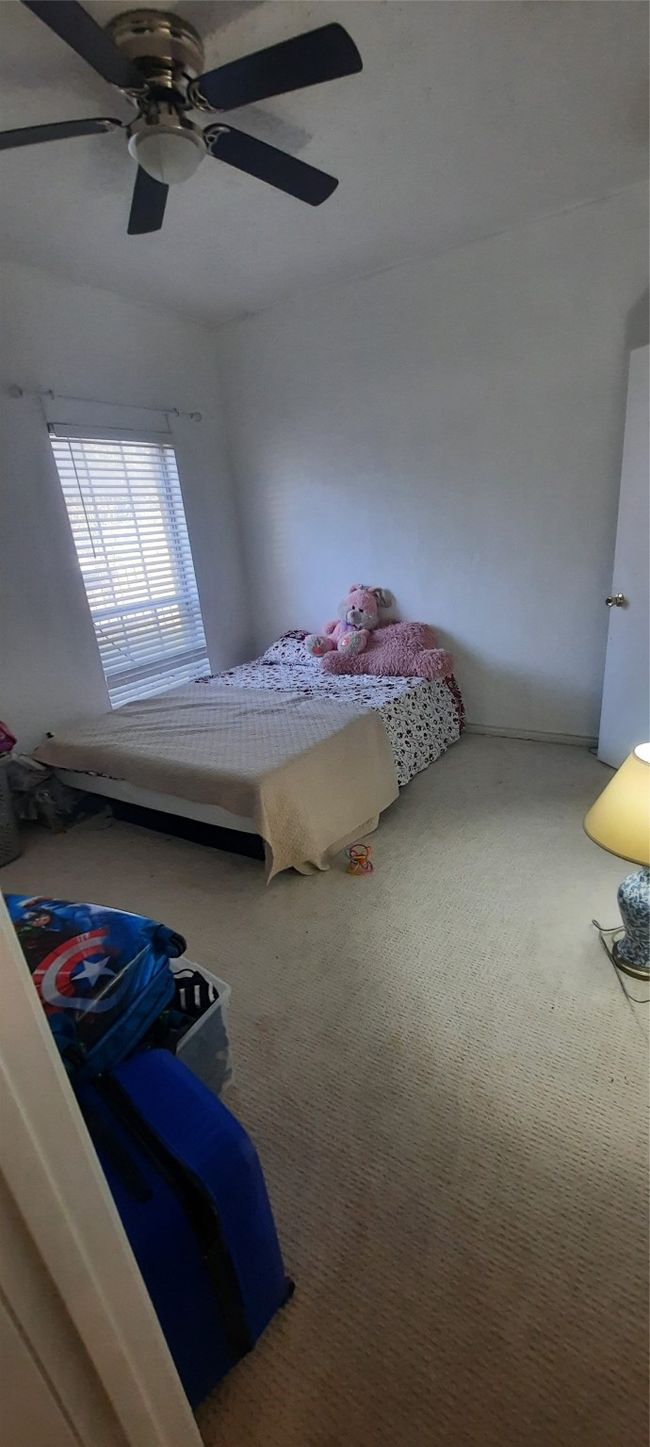 Carpeted bedroom featuring ceiling fan | Image 5