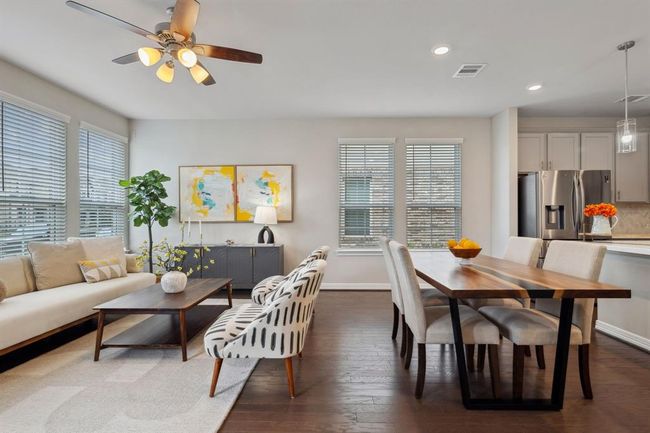 Spacious living room with an adjoining dining area. | Image 4