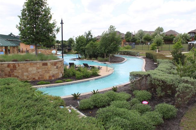 Community pool featuring fence | Image 33