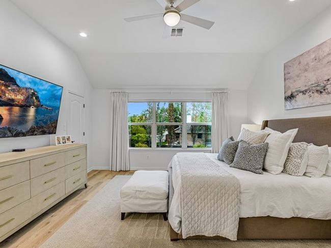 Bedroom with lofted ceiling, recessed lighting, light wood-style floors, ceiling fan, and visible vents | Image 15