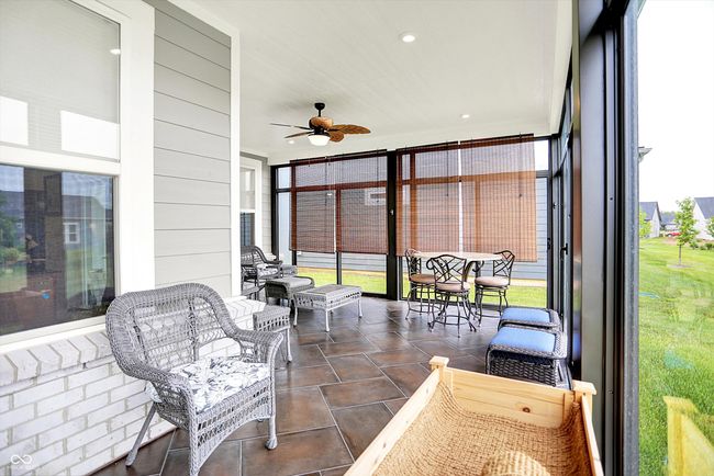 Highlight of this home is this added sunroom featuring tiled floors and ceiling fans | Image 22