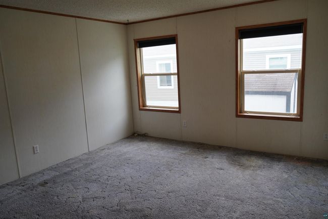Empty room featuring ornamental molding, carpet floors, and a textured ceiling | Image 22