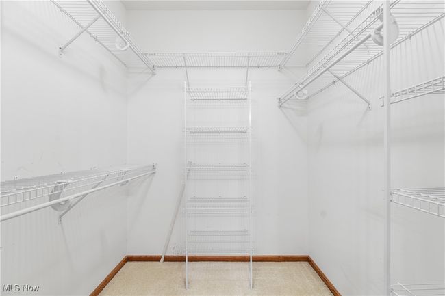 Walk-in closet with plenty of hanging bars and storage space. | Image 18