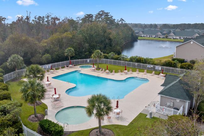 Community pool with a hot tub, a patio area, and a water view | Image 4