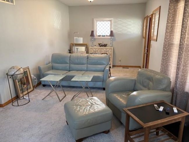 Carpeted living area with baseboards and visible vents | Image 8