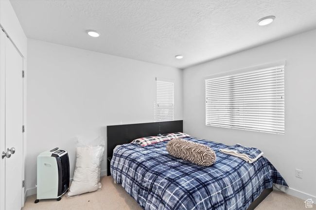 Bedroom featuring baseboards, carpet floors, a textured ceiling, and recessed lighting | Image 21