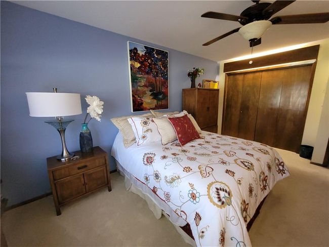Bedroom with carpet floors, a closet, and ceiling fan | Image 41