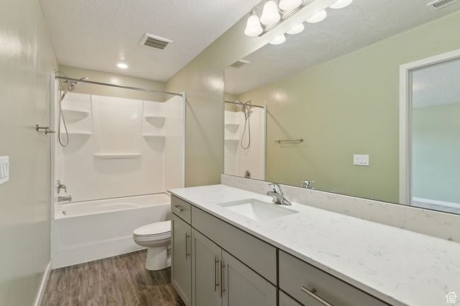 Primary Bathroom with LVP floors, toilet, vanity, and shower / tub combination | Image 17