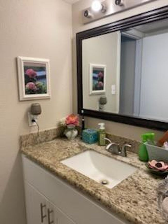 Beautiful cabinets and granite counter tops with updated faucet. | Image 9