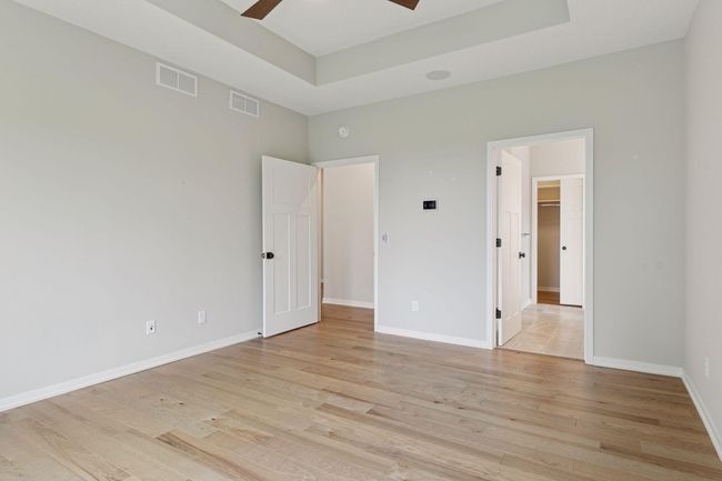 Another view of primary bedroom leading to private bath | Image 26