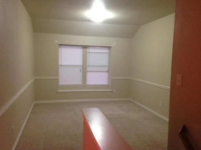 Unfurnished room with carpet and lofted ceiling | Image 7