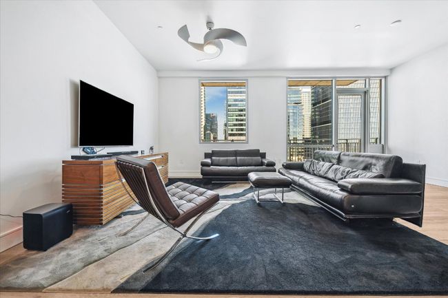 Living room featuring baseboards and wood finished floors | Image 5