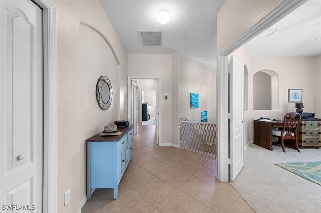 Hall featuring baseboards, visible vents, an upstairs landing, and light tile patterned floors | Image 27