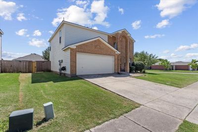 View of front of home featuring a garage and a front yard | Image 2