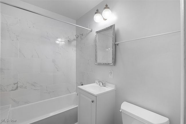 main bathroom featuring toilet, shower / tub combination, and vanity | Image 22