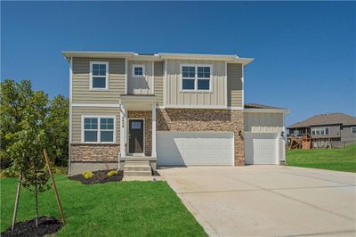 View of front of house featuring a garage and a front lawn | Image 2