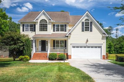 View of front facade with a porch and a front yard | Image 2