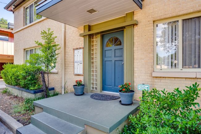 Doorway to property featuring brick siding | Image 8