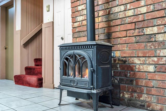 Room details with a wood stove | Image 7