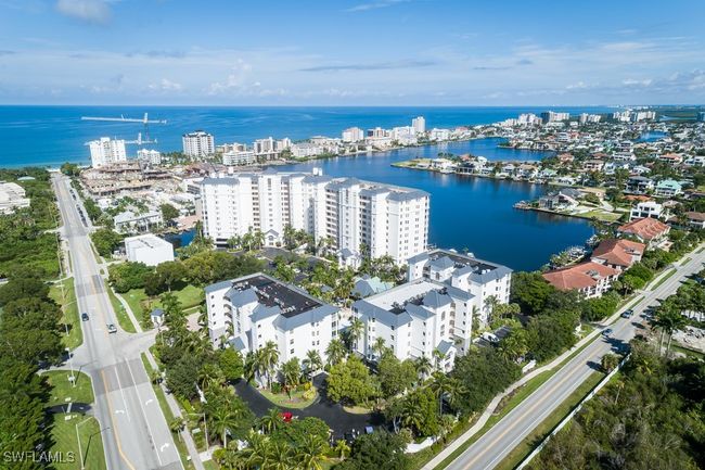 Aerial view of property and surrounding area with a large body of water, apartment complex / building, and nearby urban area | Image 18