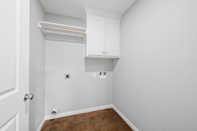 Laundry room featuring baseboards, cabinet space, washer hookup, and hookup for an electric dryer | Image 6