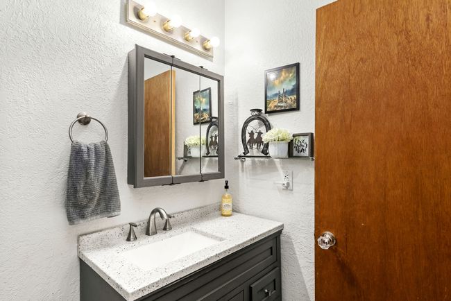 Separate apartment Bathroom with a textured wall and vanity | Image 75