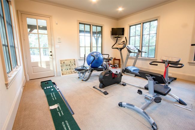 Exercise room with carpet, crown molding, baseboards, and recessed lighting | Image 15