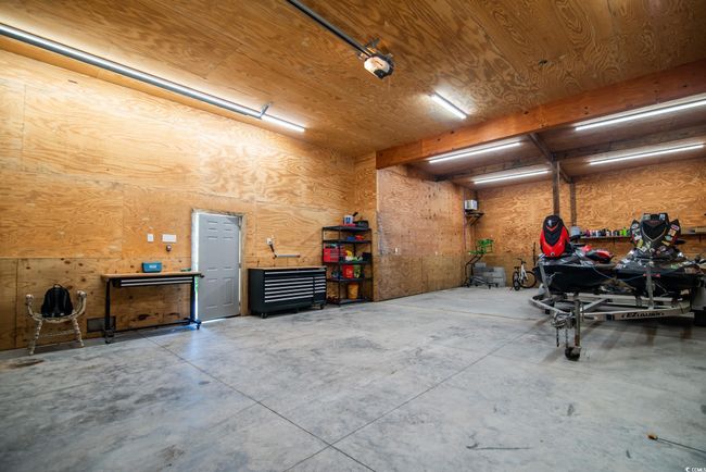 Garage with a workshop area | Image 17