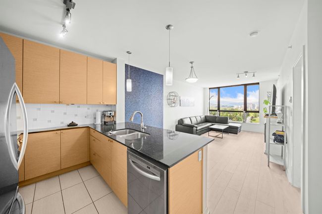 Kitchen with rail lighting, appliances with stainless steel finishes, a sink, open floor plan, and a peninsula | Image 14