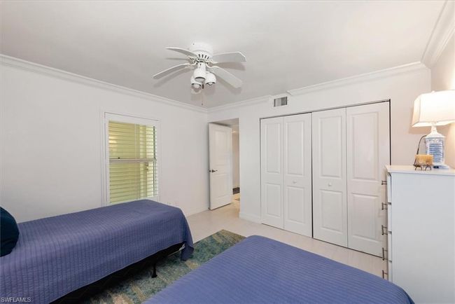 Bedroom featuring ornamental molding, a closet, and ceiling fan | Image 21