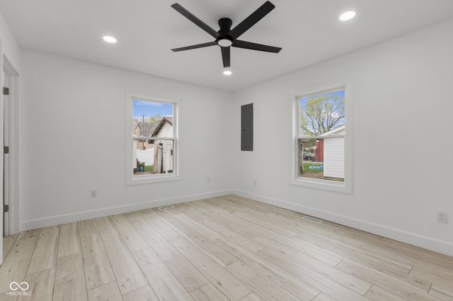 unfurnished room featuring wood finished floors, a ceiling fan, electric panel, and recessed lighting | Image 42