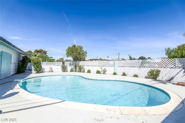 View of swimming pool featuring a fenced backyard | Image 50