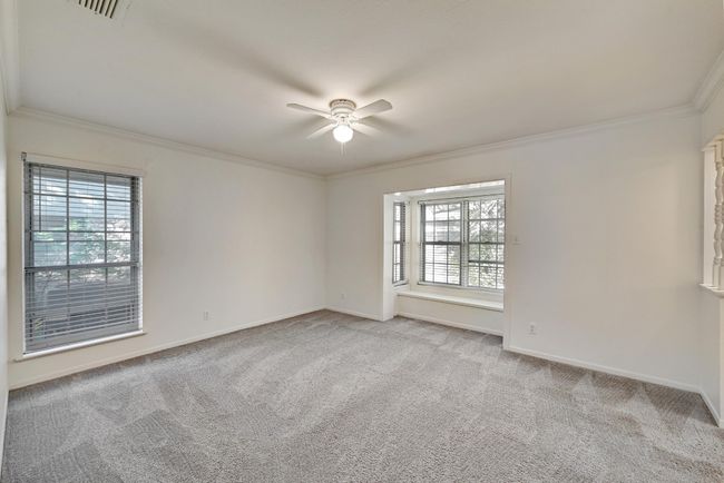 Unfurnished room featuring crown molding, a healthy amount of sunlight, and ceiling fan | Image 16