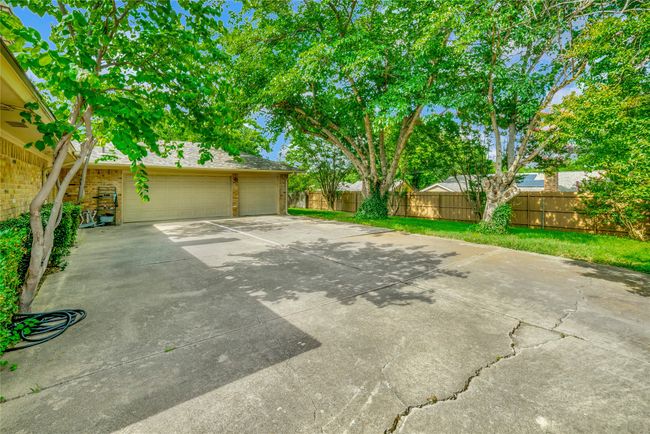 View of patio / terrace featuring a garage and concrete driveway | Image 35