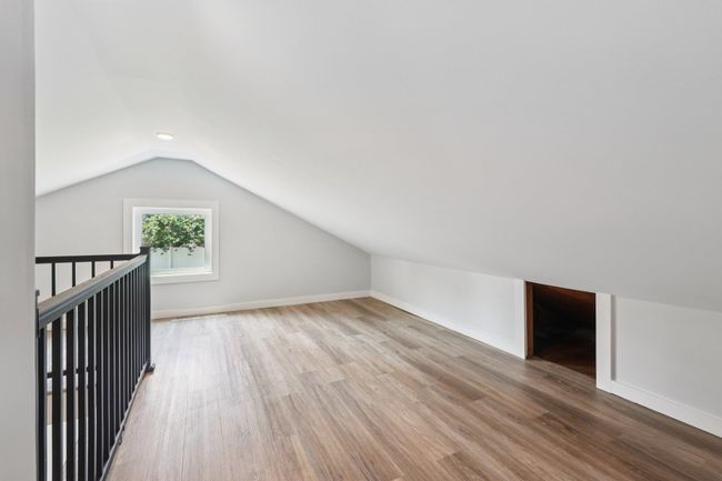 Additional living space featuring vaulted ceiling and wood finished floors | Image 23